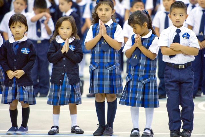 Sept. 9, 2013 - Garden Grove, California, U.S. - Children stand in prayer during the dedication ceremony for their new school, the Christ Cathedral Academy. The Most Rev. Kevin Vann, Bishop of Orange, blessed the building during the first day of school...///ADDITIONAL INFORMATION: â MINDY SCHAUER, ORANGE COUNTY REGISTER â.Shot 090913 â-.christcathedral.academy.The Most Rev. Kevin Vann, Bishop of Orange, will join students, teachers and families for the formal opening of the Roman Catholic Diocese of Orangeâs newest educational institution, the Christ Cathedral Academy. The new pre and k-8 school has the distinction of being located on the newly acquired 34 acre Christ Cathedral Campus. The school is housed within the former Family Life building and encompasses three floors and nearly 75,000 square feet. The Diocese has recently completed a more than $1.7 million renovation of the school facility. (Credit Image: © Mindy Schauer/The Orange County Register/ZUMAPRESS.com)